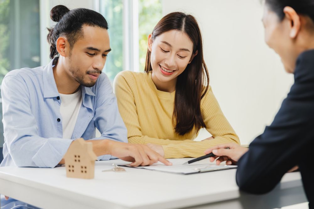 Couple signing off on legal fees buying a home
