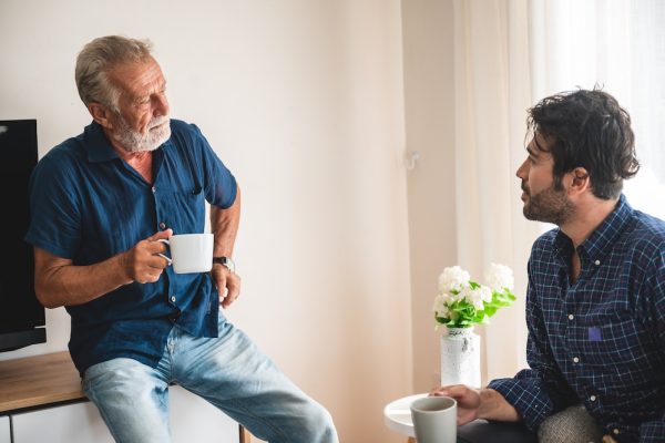 Son is talking with his father about the family home and aged care fees