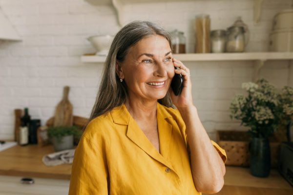 Retired Australian woman on the phone talking about age pension